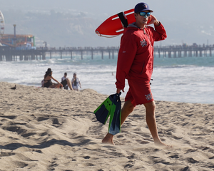 Lifeguard on the beach wearing Nöz’s reef safe zinc sunscreen in neon blue on his nose