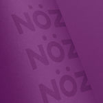 Load image into Gallery viewer, Close up of Nöz’s logo, on its cruelty free sunscreen stick, in the color neon purple.
