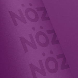 Close up of Nöz’s logo, on its cruelty free sunscreen stick, in the color neon purple.