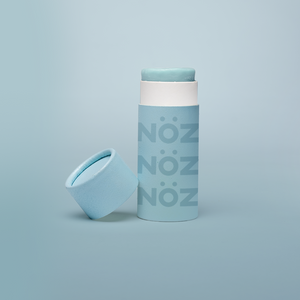 Nöz’s natural zinc and vegan sunscreen stick in neon blue, with its cap off.